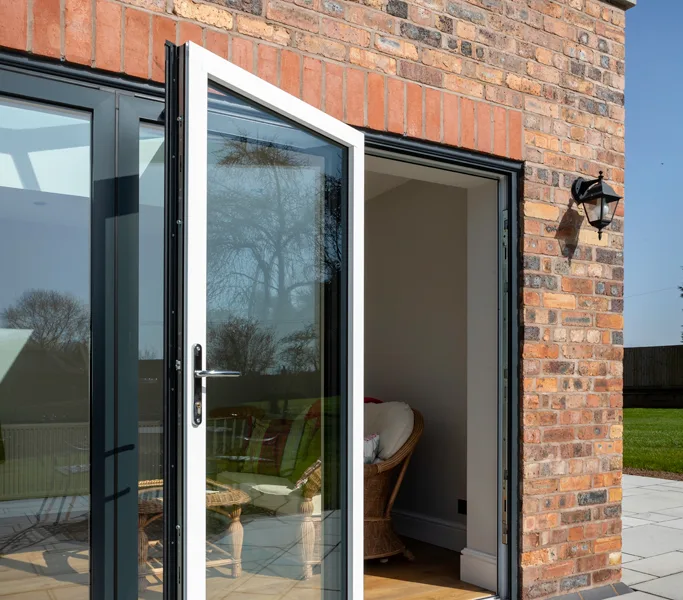 Anthracite grey aluminium bifold doors on a red brick property in Manchester